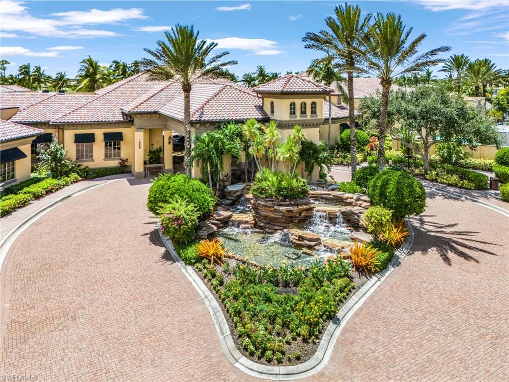 9113 Michael Circle, Unit 7 Naples, FL 34113 - Photo 32 of 34 a view of a garden with a patio