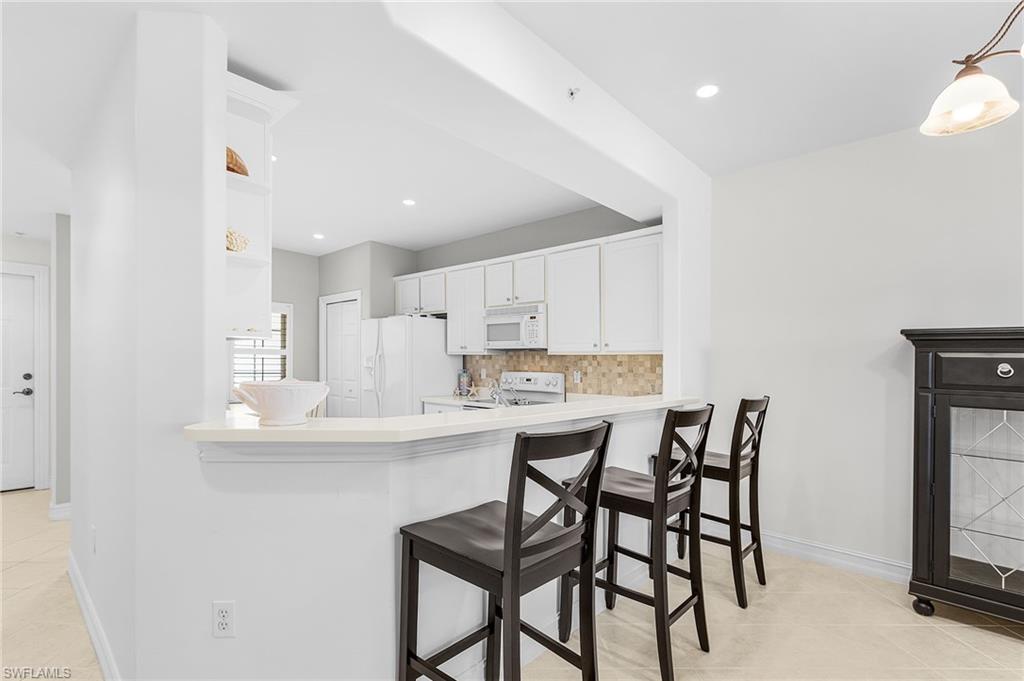 9113 Michael Circle, Unit 7 Naples, FL 34113 - Photo 10 of 34 a view of a dining room with furniture