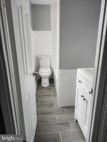 a white toilet sitting next to a white sink