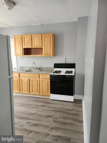 a kitchen with stainless steel appliances a stove a sink and a microwave