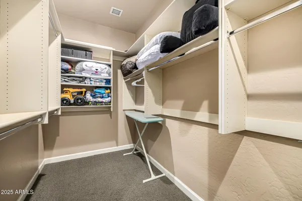 a bedroom with a bed couch and dresser