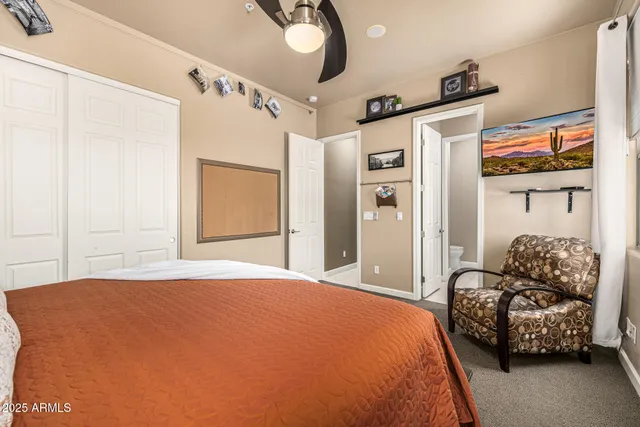 an empty room with a ceiling fan and window