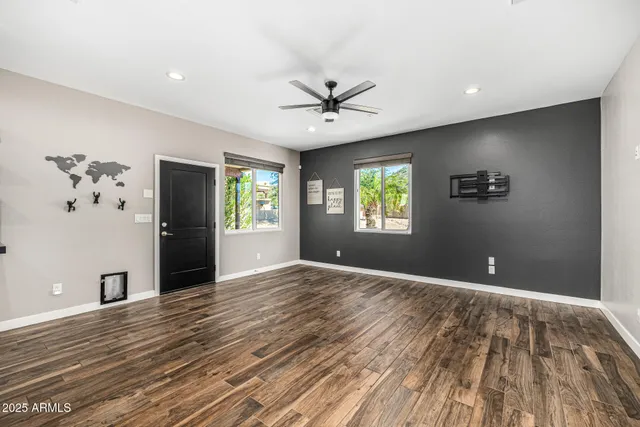 a view of a patio with a table and chairs under an umbrella