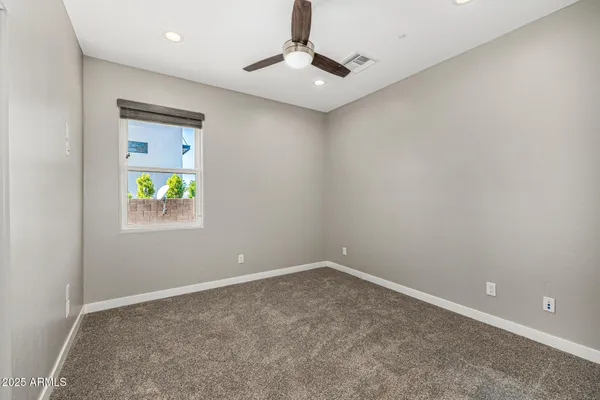 a view of a backyard with plants and a patio