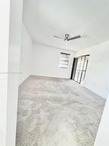 a view of an empty room with windows