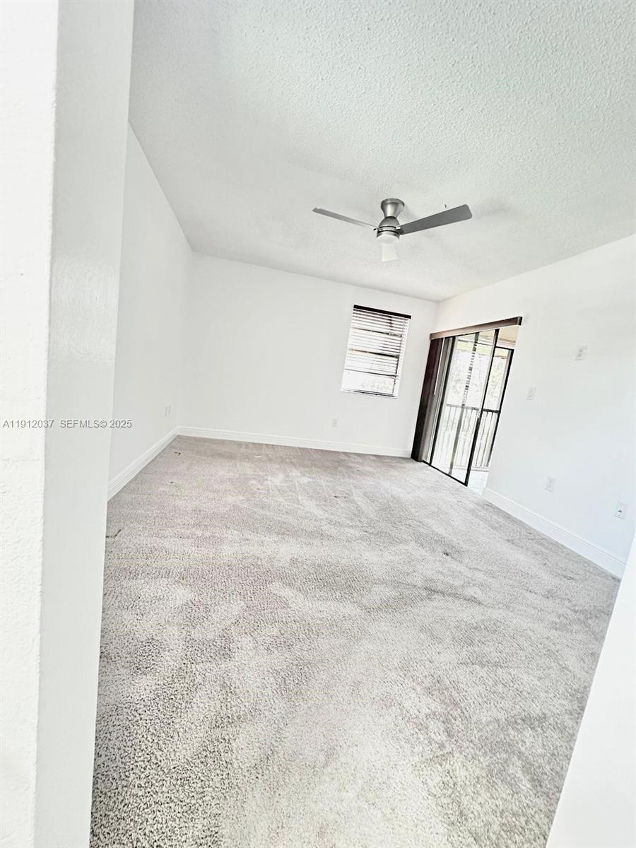 8632 Northwest 34th Place, Unit C207 Sunrise, FL 33351 - Photo 9 of 19 a view of an empty room with windows