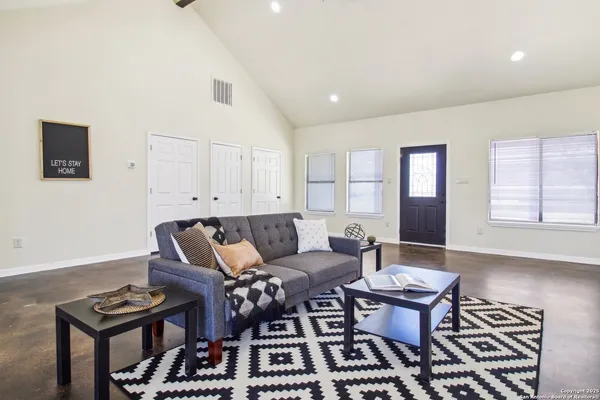 a living room with furniture and wooden floor