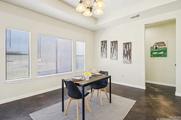 a open dining room with kitchen island furniture a chandelier and kitchen view