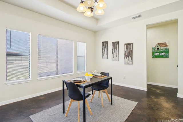 a open dining room with kitchen island furniture a chandelier and kitchen view