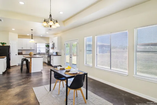 a kitchen with granite countertop a sink stove and refrigerator