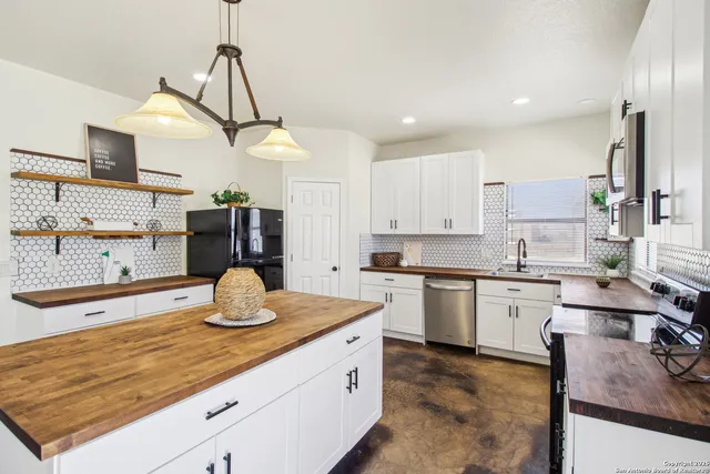 a kitchen with a sink stove and microwave
