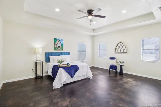 a bedroom with a bed and a ceiling fan