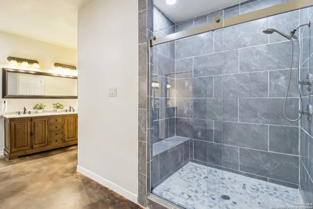 an empty room with closet and a chandelier fan
