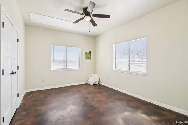 a workspace with wooden floor and a window