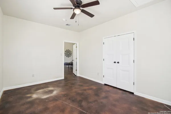 a view of a livingroom with furniture and fan