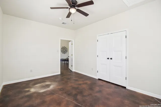 a view of a livingroom with furniture and fan