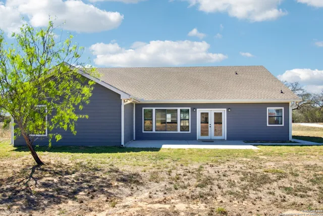 an aerial view of a houses with beach