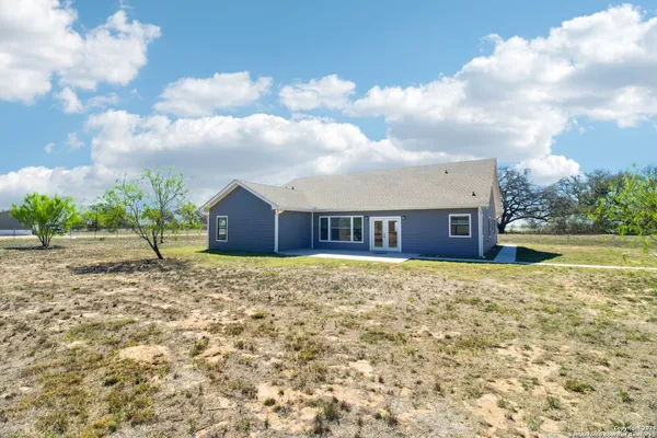 a view of a house with a backyard