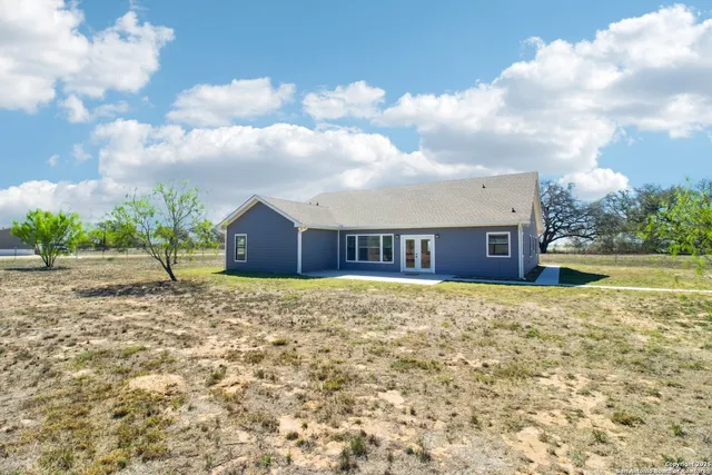 a view of a house with a backyard