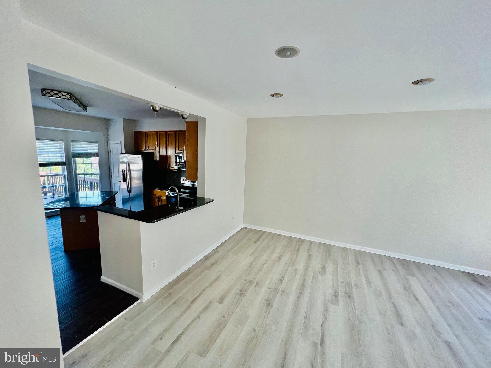 13251 Revillo Loop Woodbridge, VA 22191 - Photo 15 of 32 wooden floor in an empty room with a window