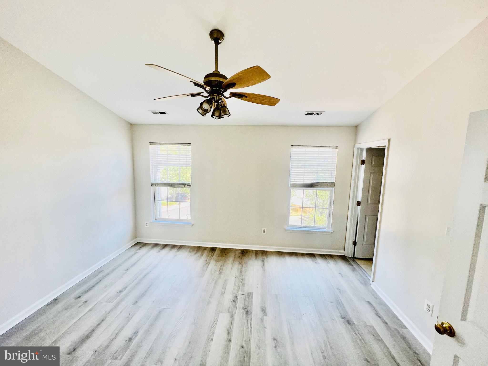 13251 Revillo Loop Woodbridge, VA 22191 - Photo 18 of 32 a view of room with wooden floor and window