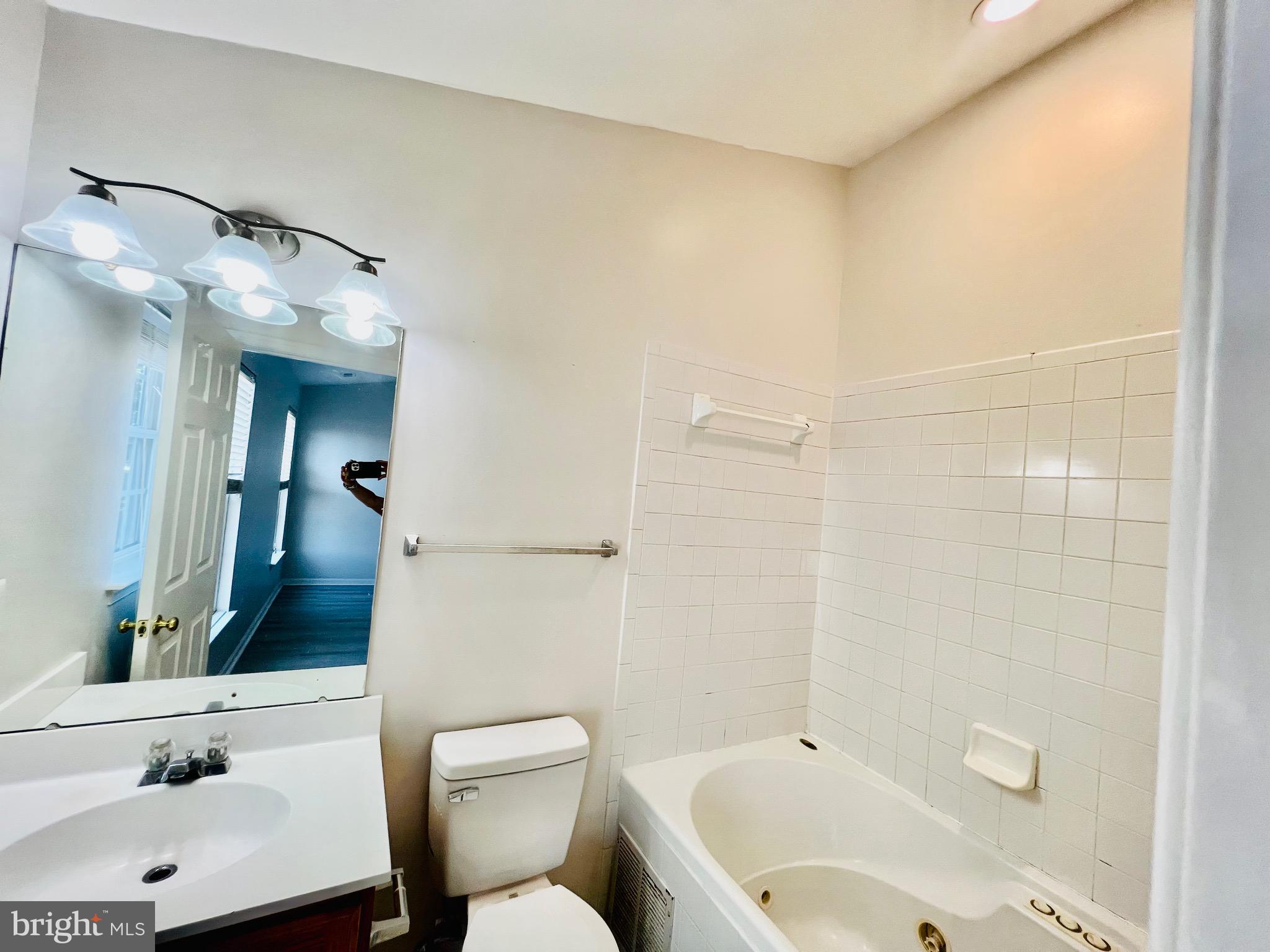 13251 Revillo Loop Woodbridge, VA 22191 - Photo 22 of 32 a bathroom with a sink mirror vanity and toilet