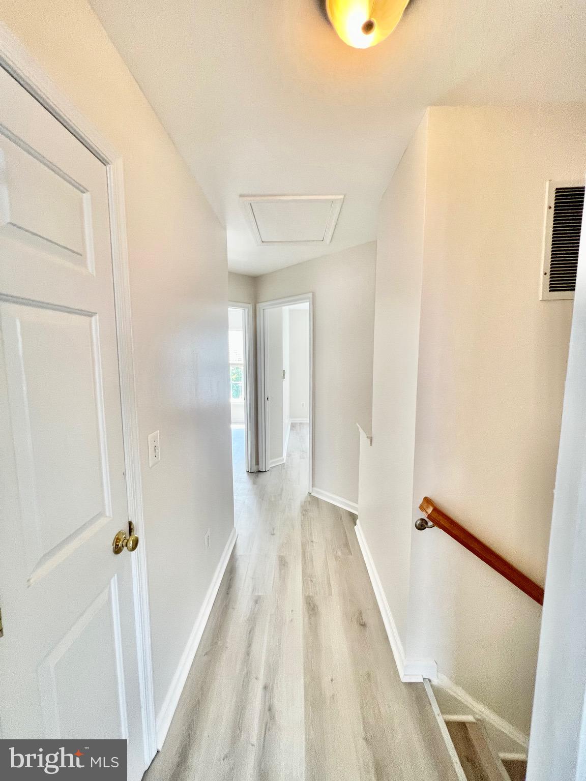 13251 Revillo Loop Woodbridge, VA 22191 - Photo 26 of 32 a view of a hallway with wooden floor and entryway