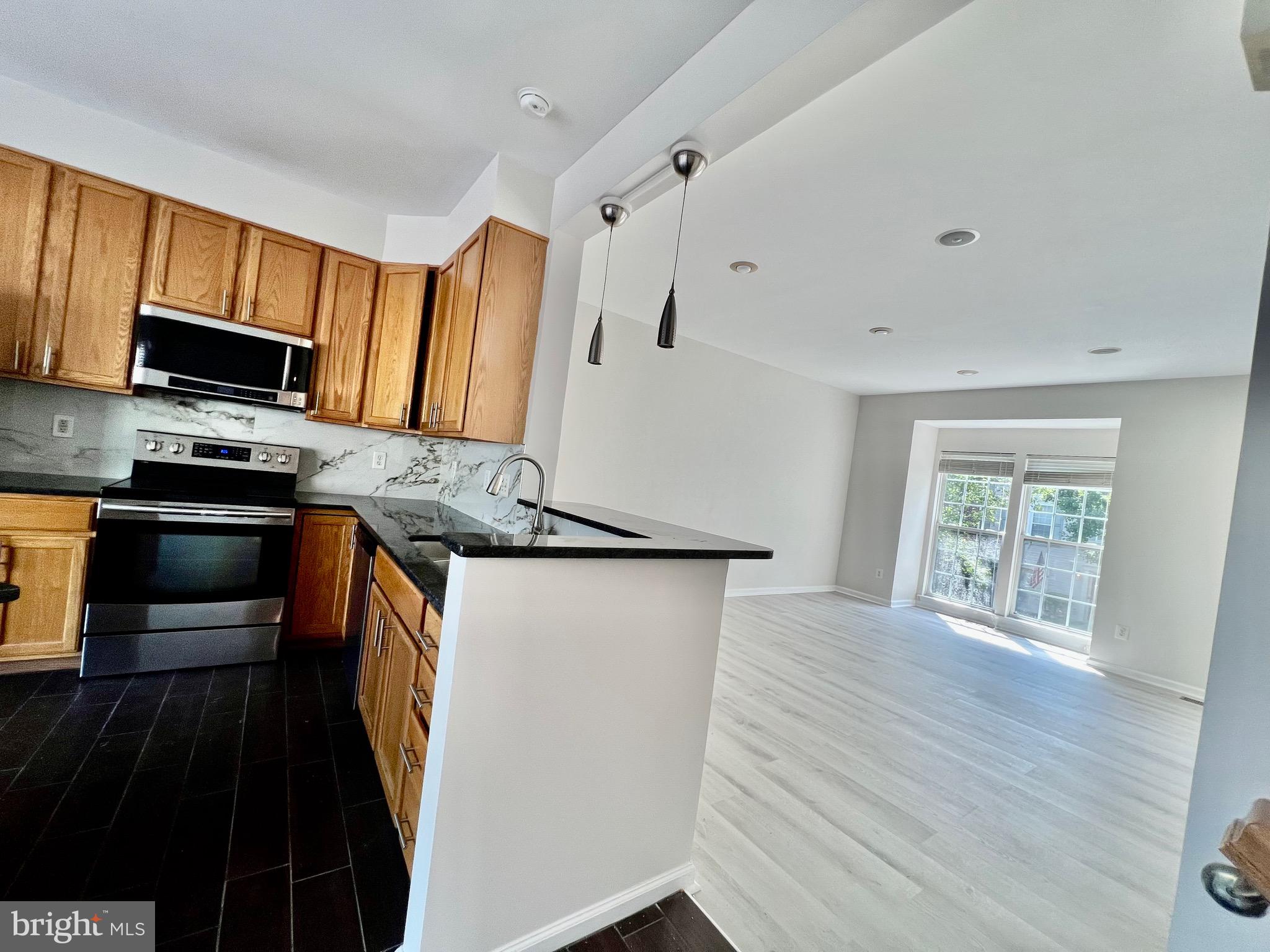 13251 Revillo Loop Woodbridge, VA 22191 - Photo 30 of 32 a kitchen with stainless steel appliances a refrigerator stove microwave and sink