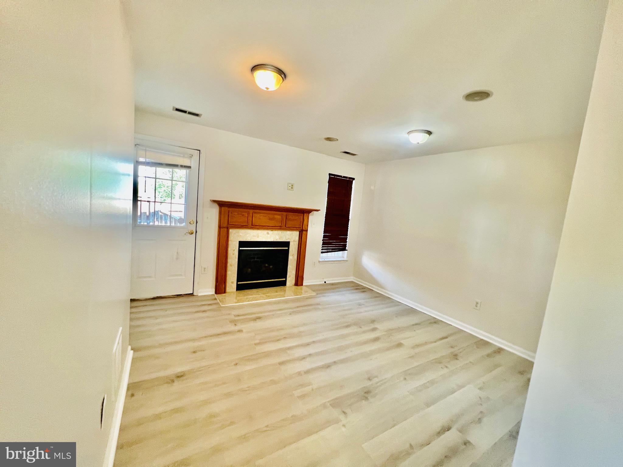 13251 Revillo Loop Woodbridge, VA 22191 - Photo 3 of 32 a view of empty room with a fireplace and a window