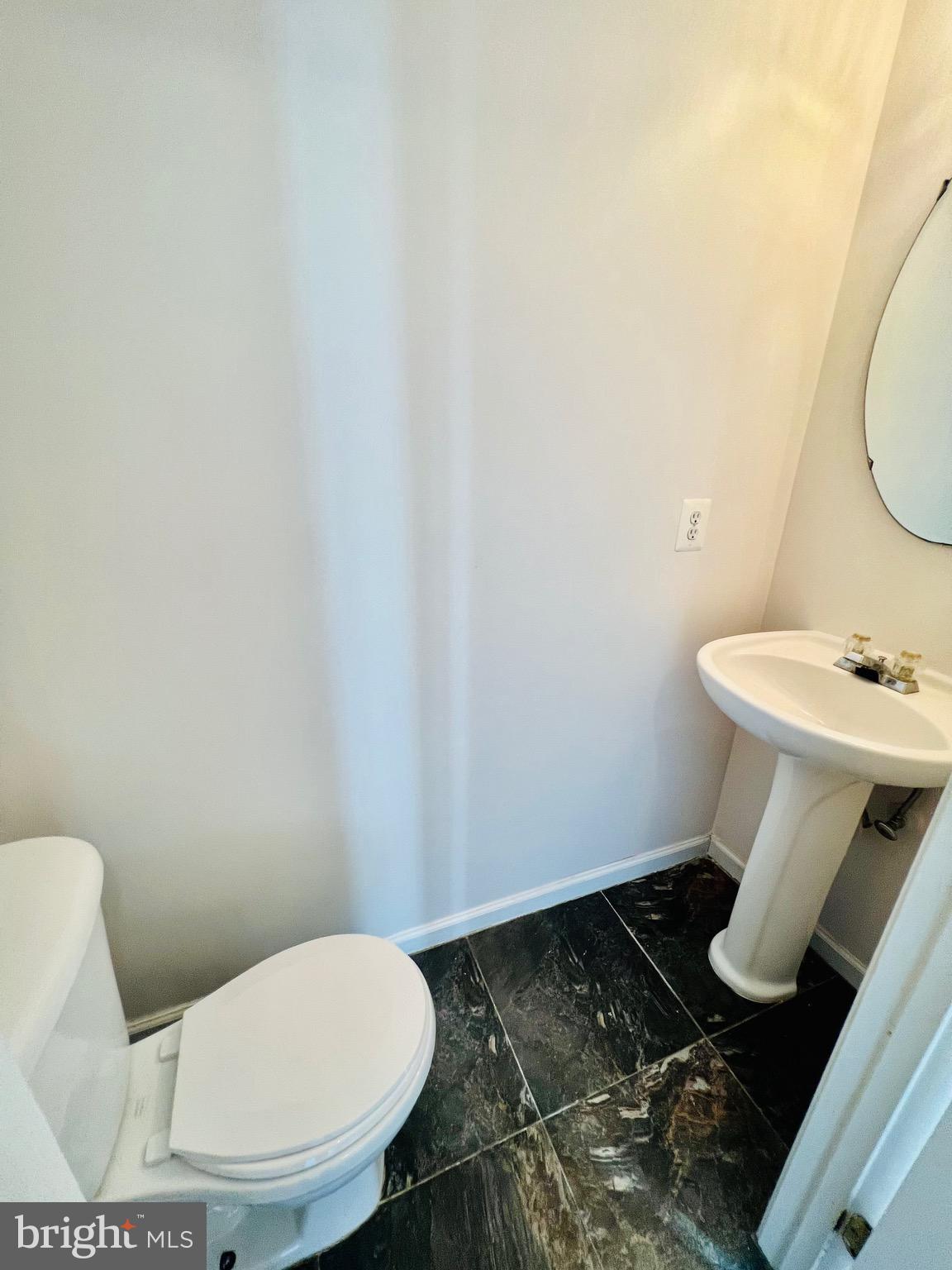 13251 Revillo Loop Woodbridge, VA 22191 - Photo 7 of 32 a bathroom with a toilet and a sink