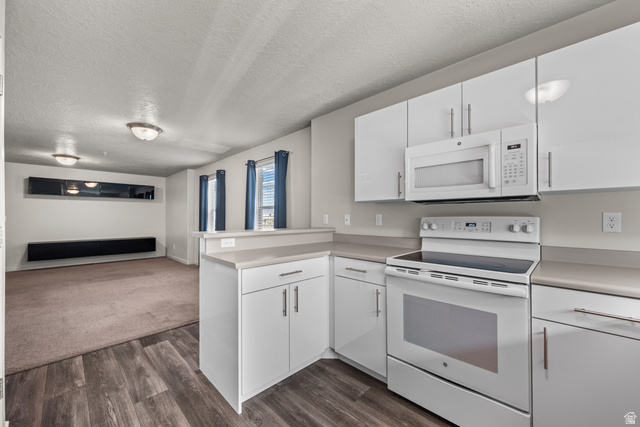 1700 South Sandhill Road West, Unit E 301 Orem, UT 84058 - Photo 10 of 20 Modern kitchen featuring white cabinetry, light countertops, wood-finish flooring, and white appliances
