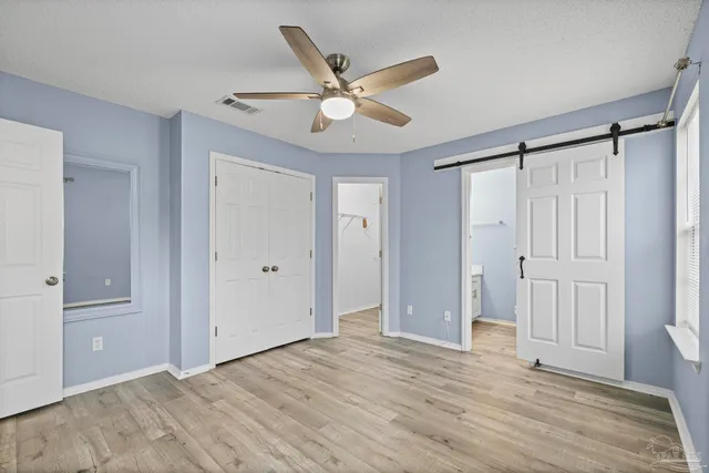 a view of an empty room with a ceiling fan