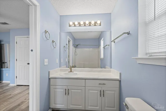 a bathroom with a sink a toilet and a mirror