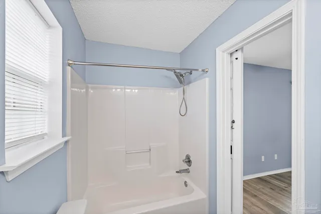 a bathroom with a shower and a bath tub