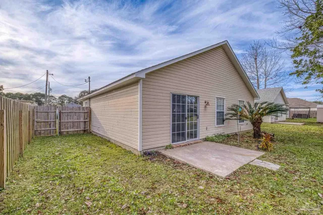 a view of a house with a backyard