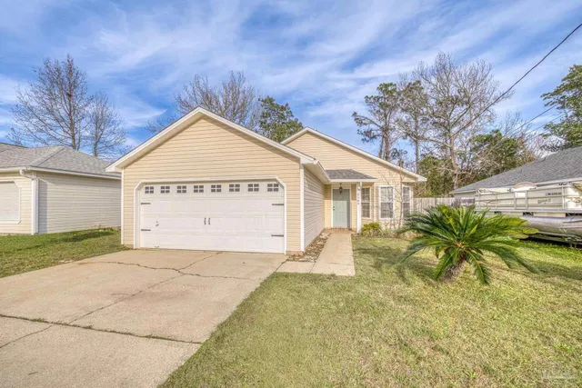 a view of a white house with a large space