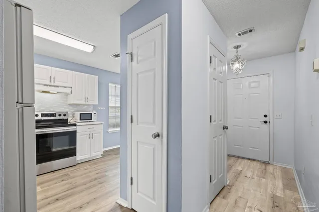 a kitchen with cabinets and stainless steel appliances