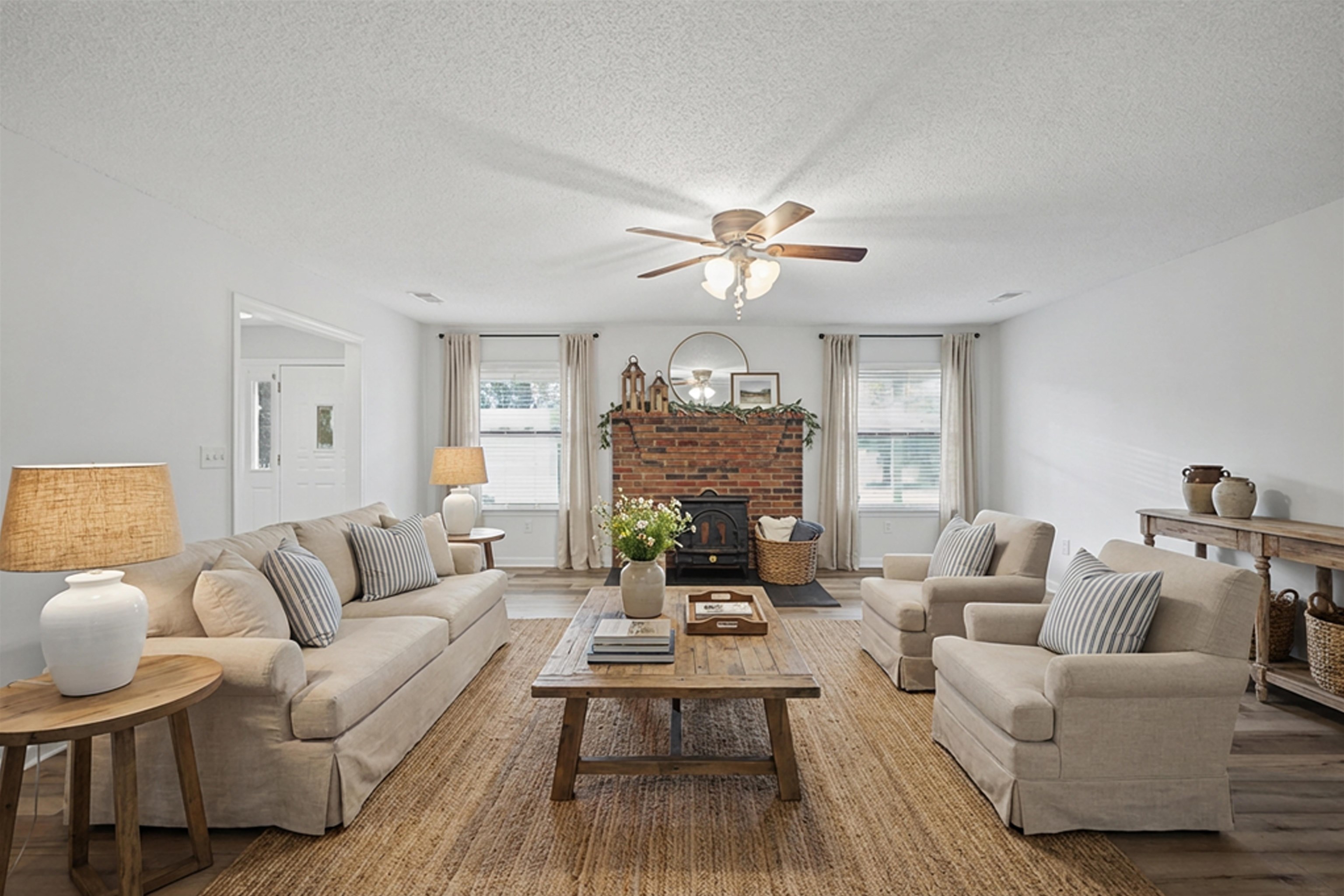 632 Cullum Road Munford, TN 38058 - Photo 12 of 38 Staged with Ai Living room with wood finished floors, healthy amount of natural light, ceiling fan, and a textured ceiling
