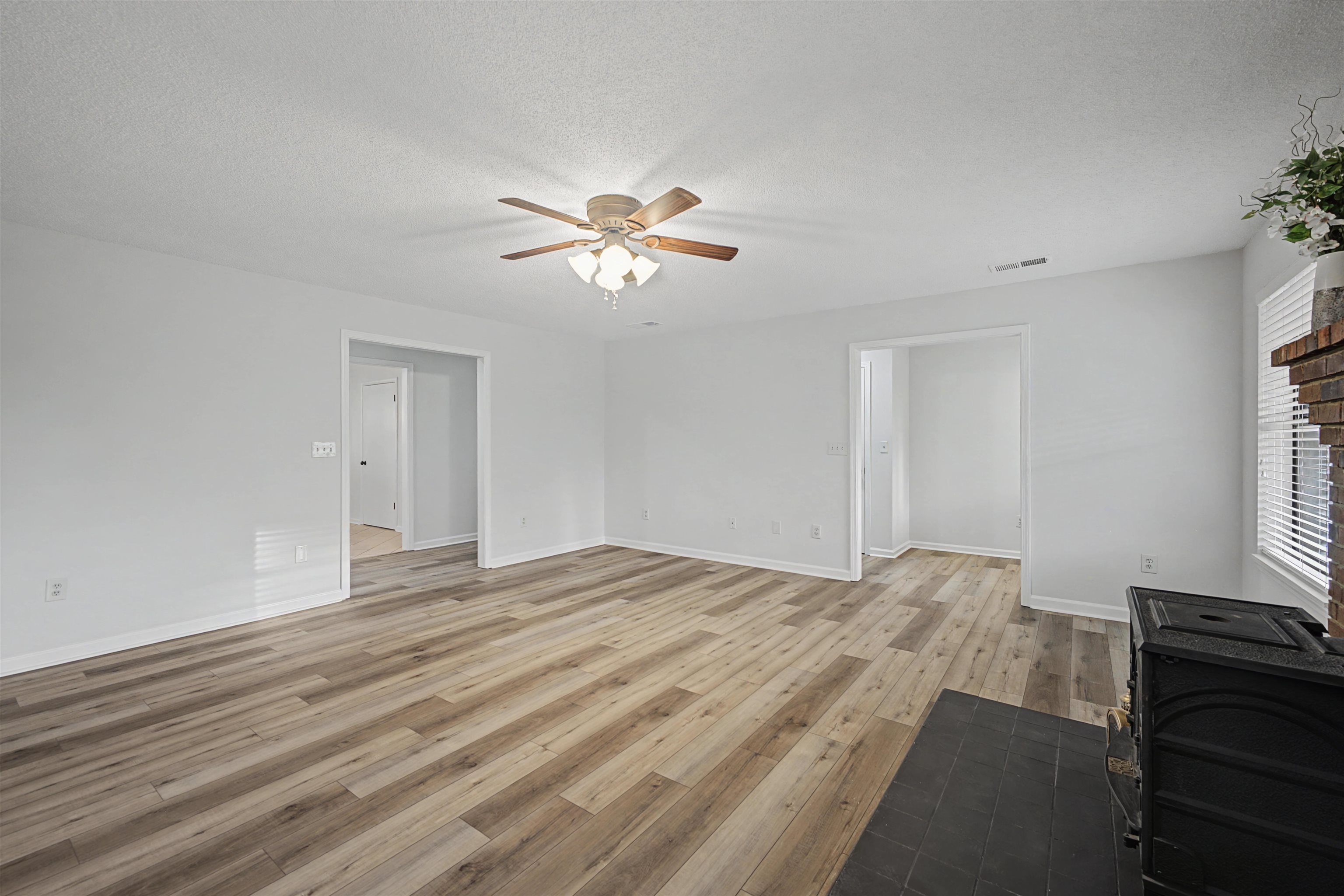 632 Cullum Road Munford, TN 38058 - Photo 15 of 38 Unfurnished living room featuring light wood-style flooring, a textured ceiling, and ceiling fan