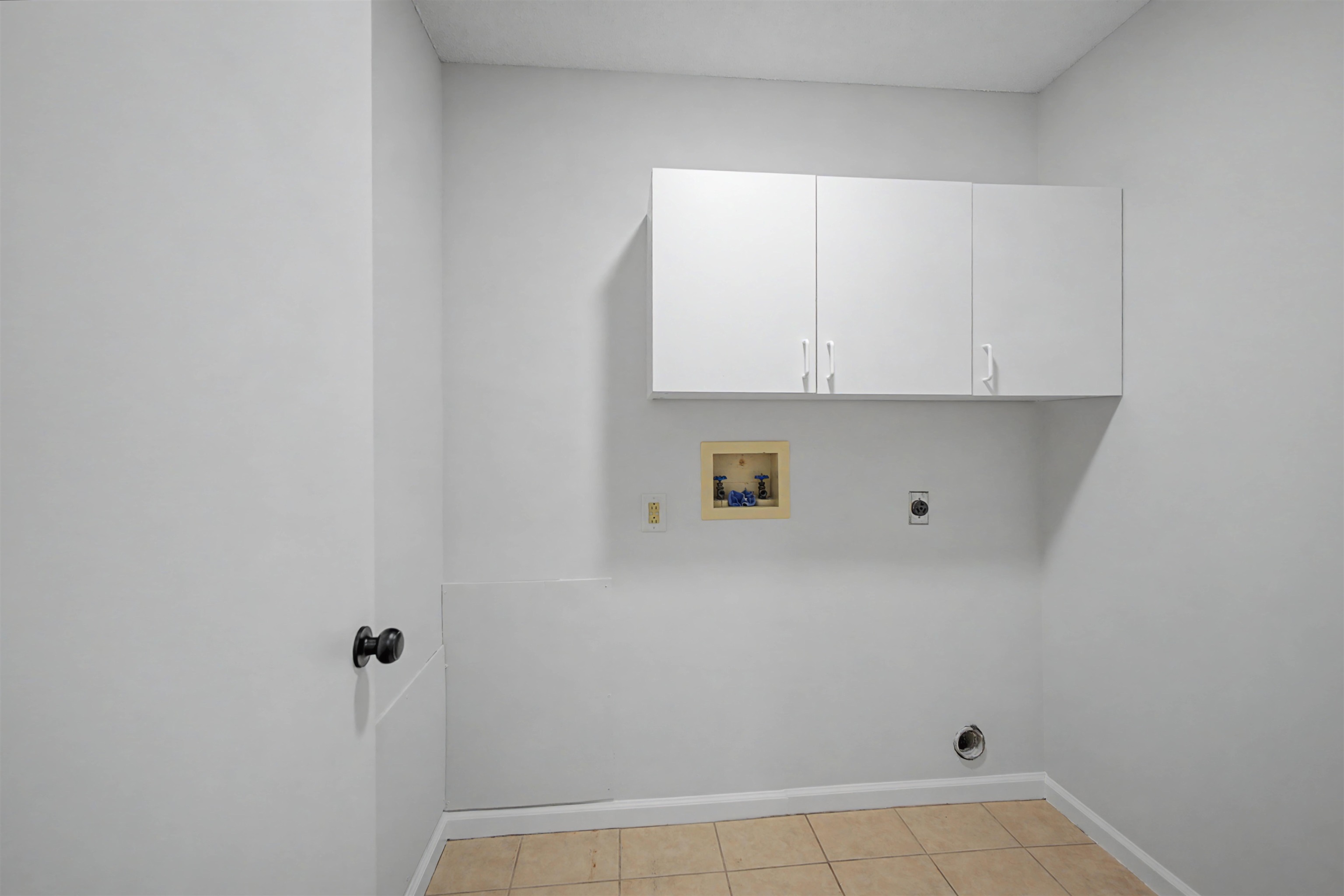 632 Cullum Road Munford, TN 38058 - Photo 19 of 38 Laundry area with hookup for an electric dryer, cabinet space, hookup for a washing machine, and light tile patterned floors