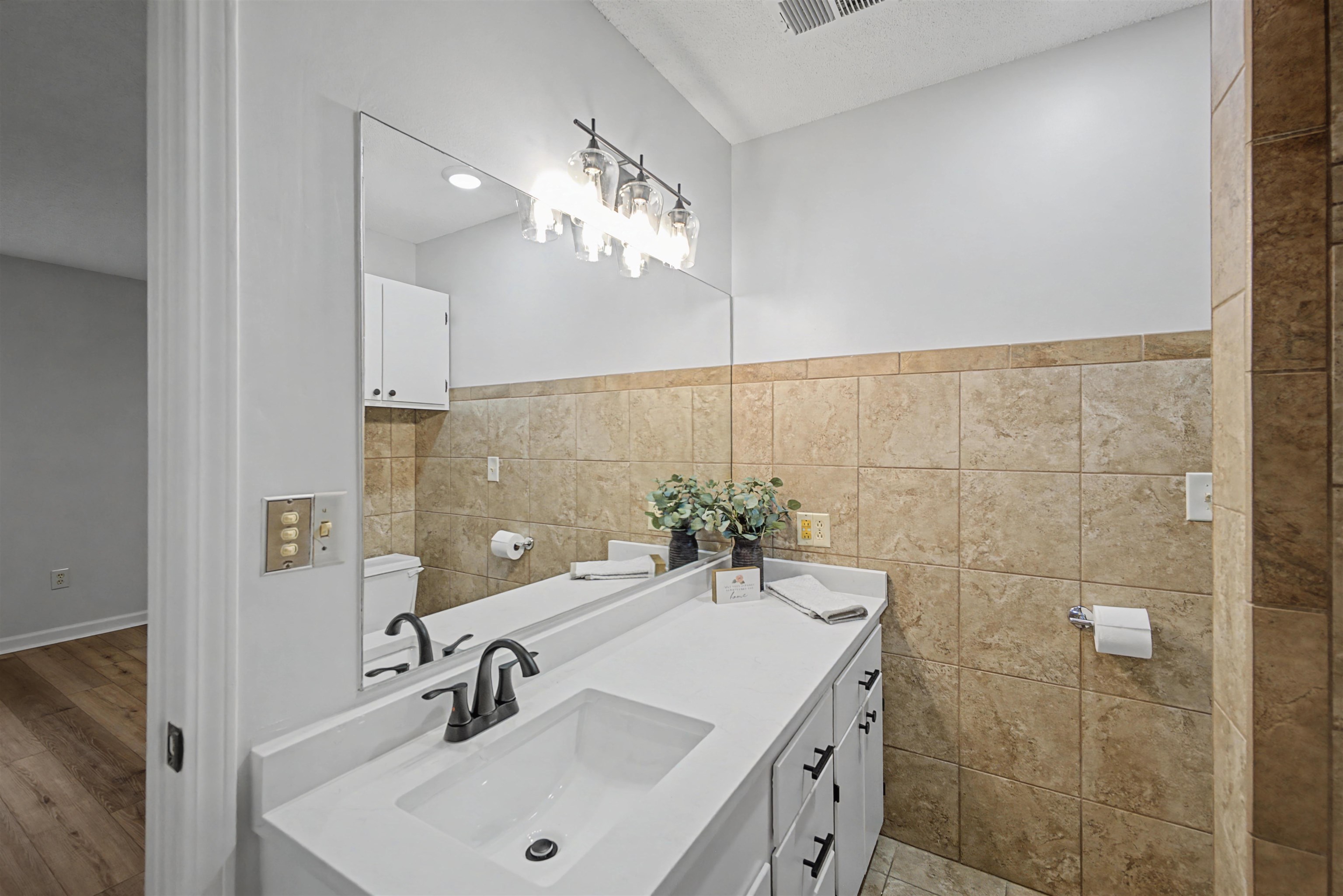 632 Cullum Road Munford, TN 38058 - Photo 25 of 38 Half bathroom featuring vanity and tile walls