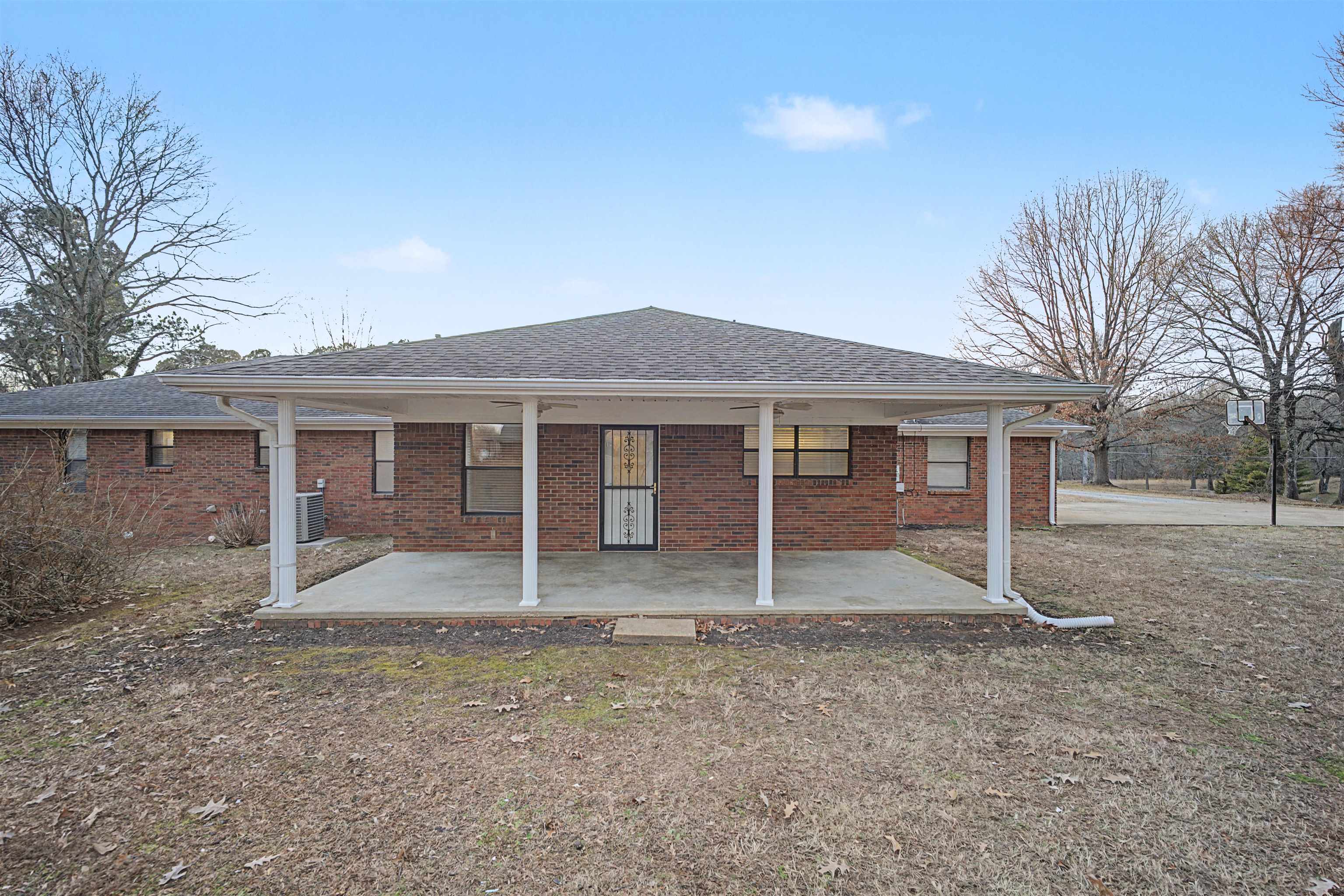 632 Cullum Road Munford, TN 38058 - Photo 3 of 38 Rear view of house with a shingled roof, brick siding, and a patio