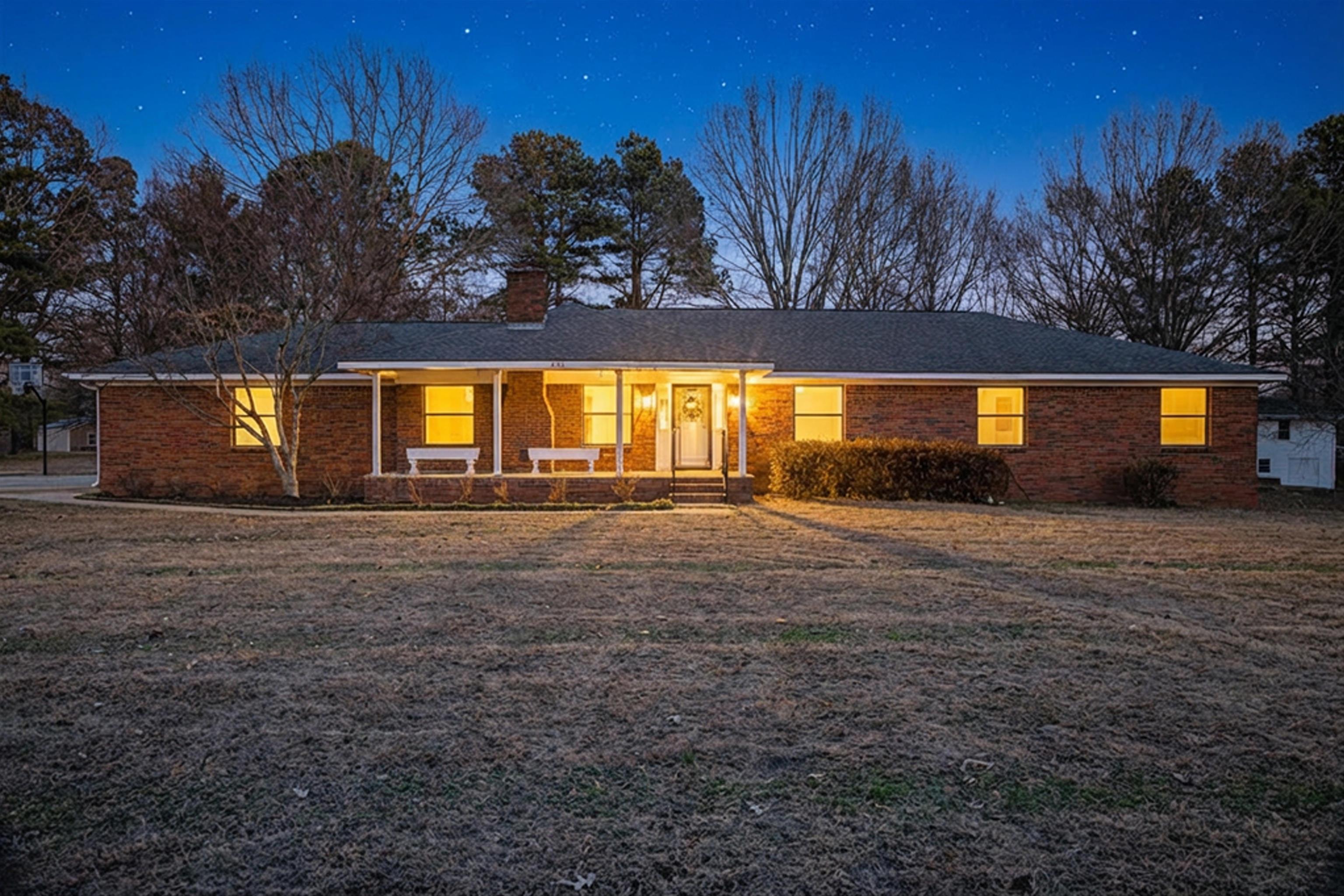 632 Cullum Road Munford, TN 38058 - Photo 5 of 38 Staged with Ai Single story home featuring covered porch, a chimney, brick siding, and a front yard