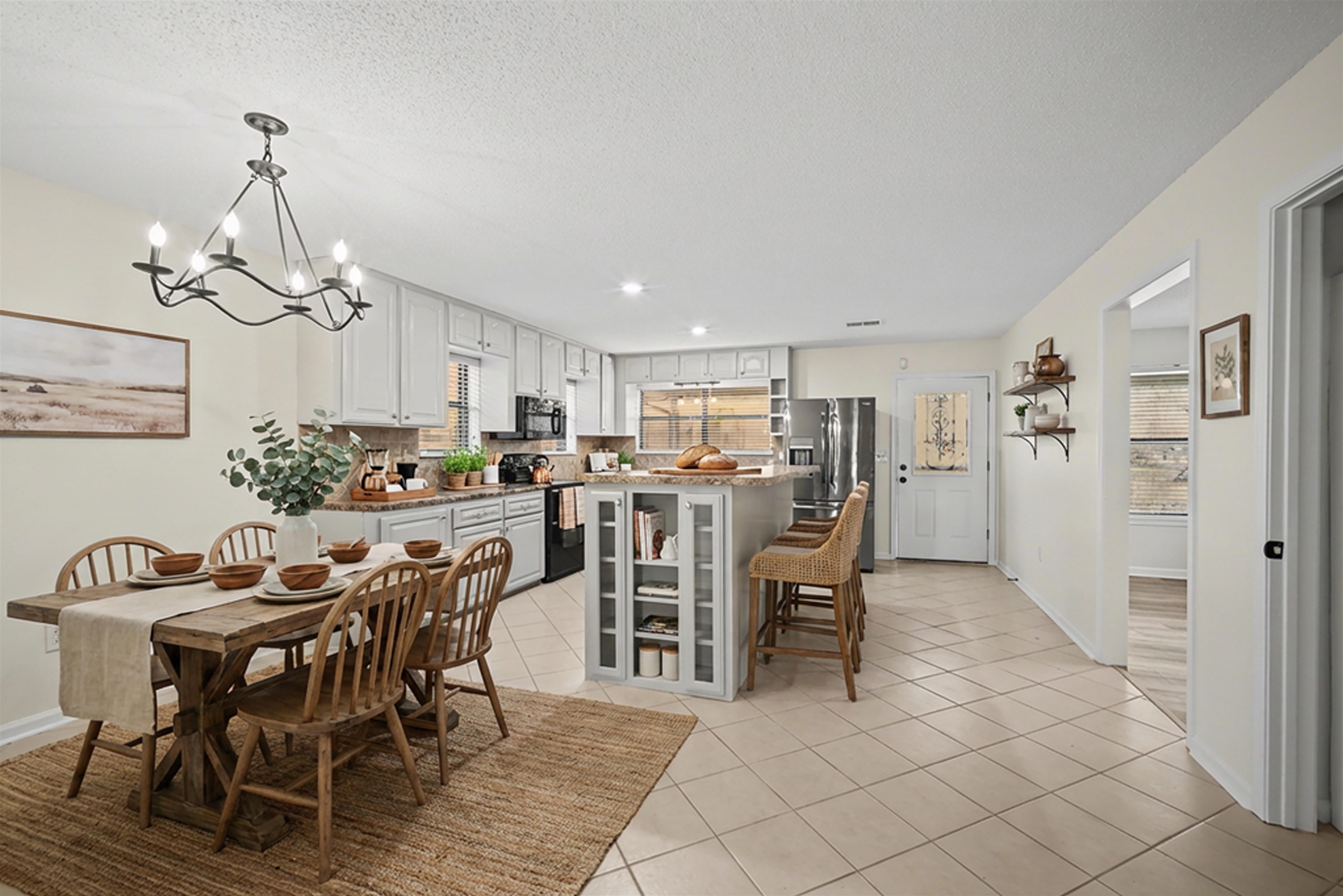 632 Cullum Road Munford, TN 38058 - Photo 7 of 38 Staged with Ai Dining space with light tile patterned floors, suspended lighting, and a textured ceiling