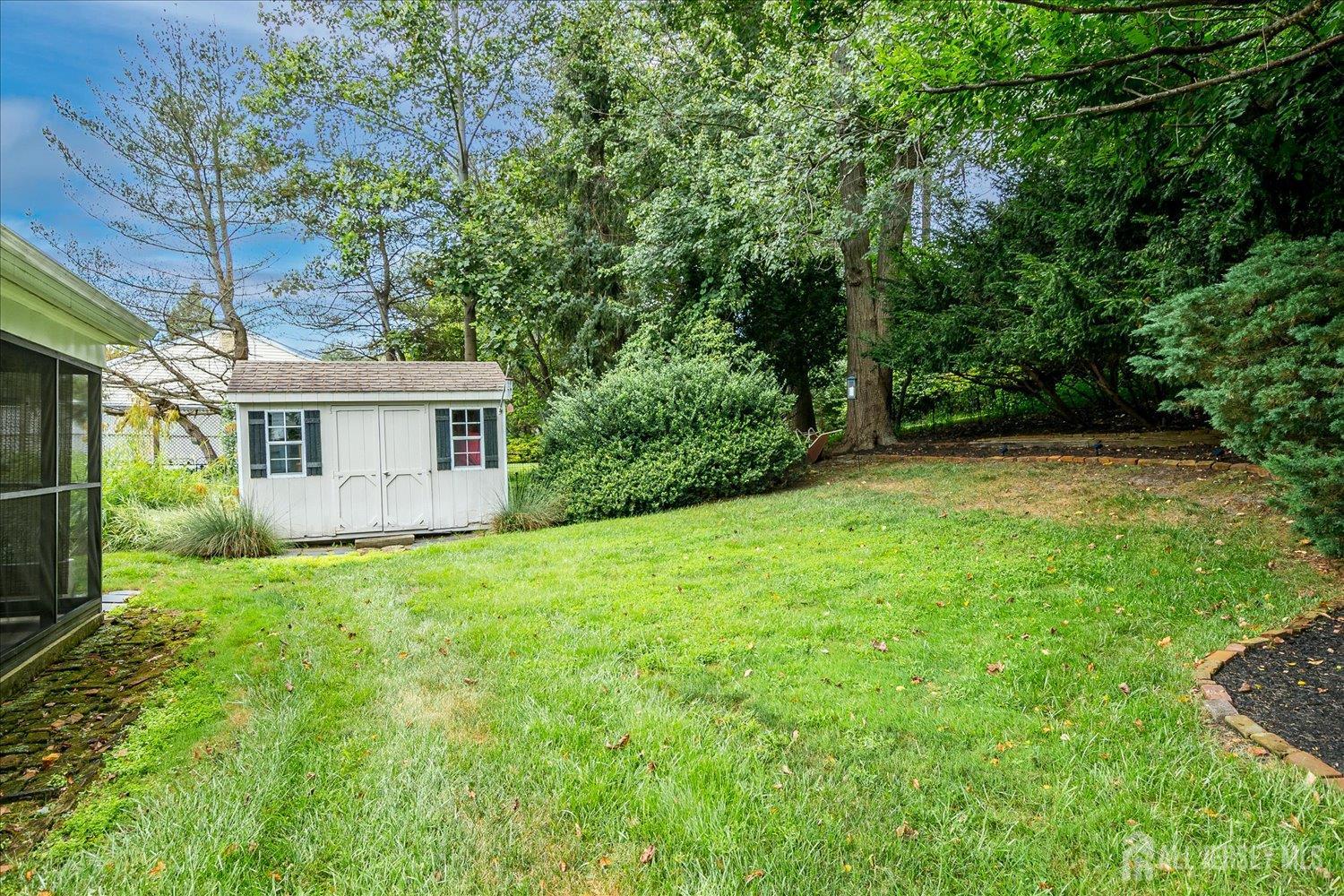 240 Dwight Road Middletown, NJ 07748 - Photo 13 of 28 a view of a house with backyard and garden