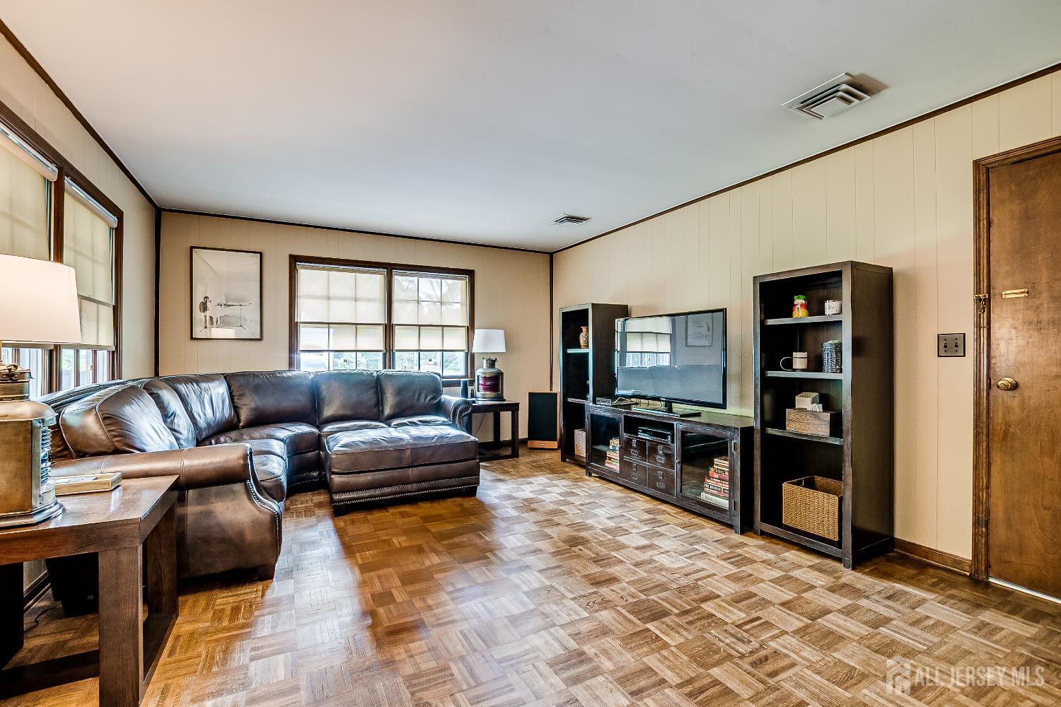 240 Dwight Road Middletown, NJ 07748 - Photo 23 of 28 a living room with furniture and a flat screen tv