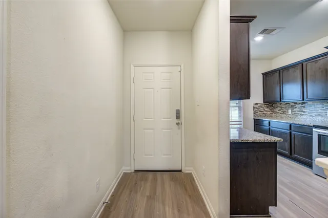 a view of a kitchen from the hallway