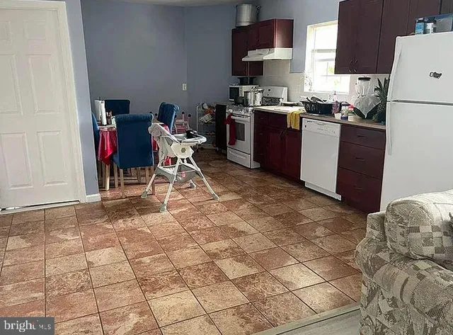 a kitchen with a stove a sink and a refrigerator