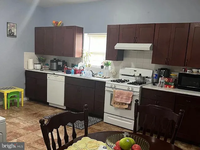 a white toilet sitting next to a white sink and vanity