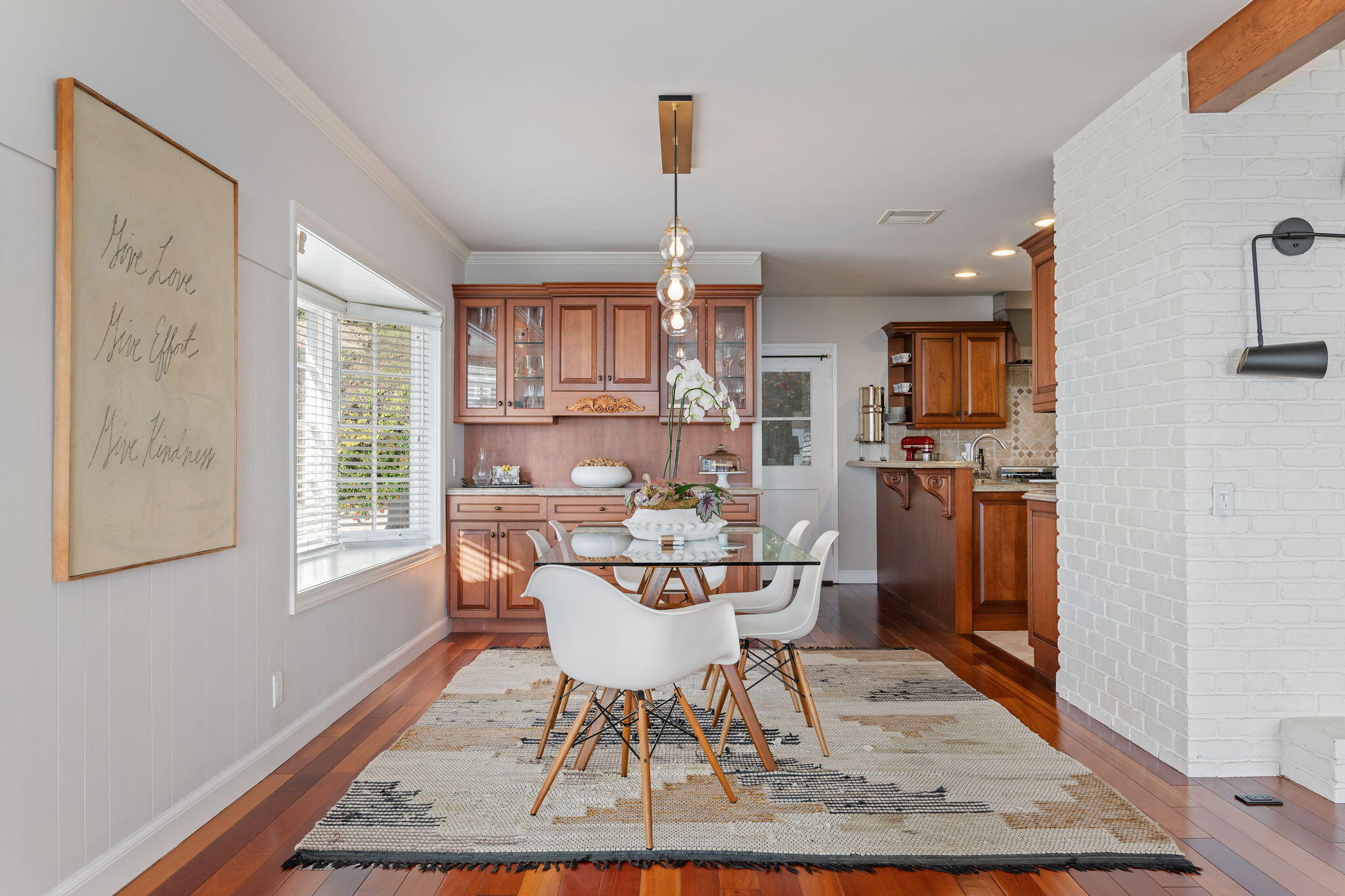 712 Arbolado Road Santa Barbara, CA 93103 - Photo 16 of 28 a dining room with furniture a rug and wooden floor